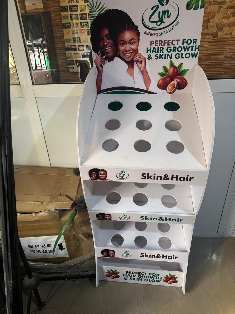 The Zyn Skin and Hair stand standing in a shop in front of a cigarette gantry.