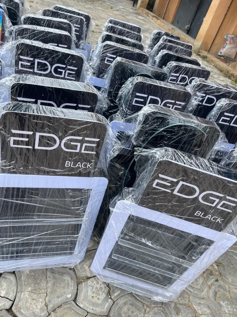 A large batch of Edge Black counter displays wrapped and grouped outdoors.