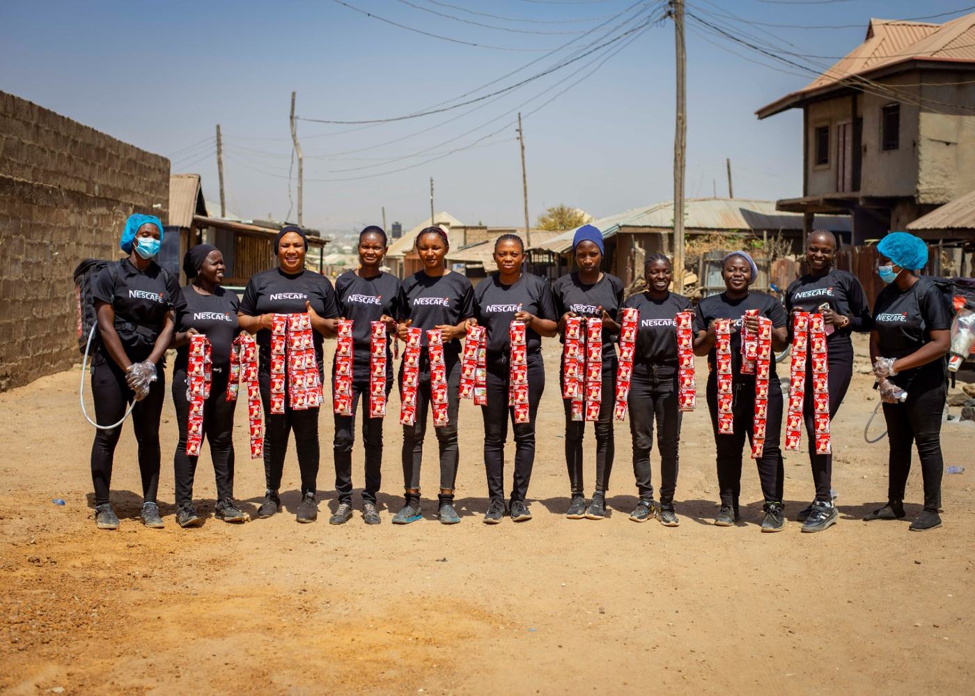 The full Nescafe team spread along the street holding sachet strips.