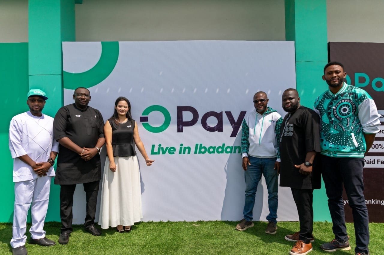 Six people standing in front of an OPay Live in Ibadan launch backdrop.