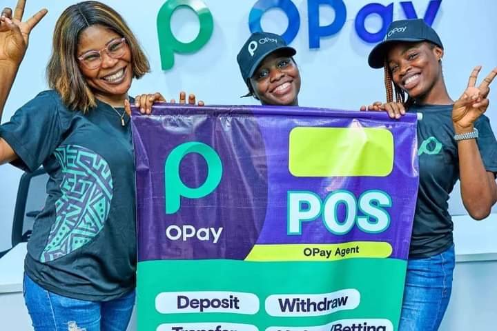 Three OPay staff holding a purple and green OPay POS agent banner.
