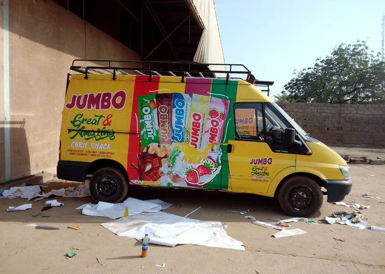 A delivery van fully wrapped in Jumbo corn snack branding.